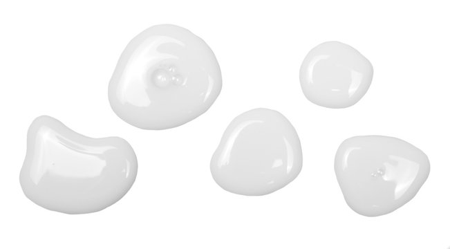 Spilled milk puddle isolated on white background and texture, top view