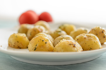 Roasted young potatoes with herbs close-up