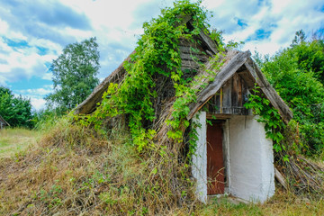 Folk oldest habitation under a reed roof in the disappearing village of Svalovichi in the Ukraine. Ukrainian Polissya.