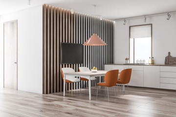 White and wooden kitchen corner with TV