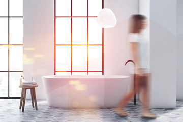 Woman walking in white bathroom