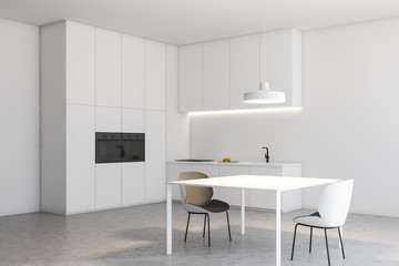 White loft kitchen corner with table and counters