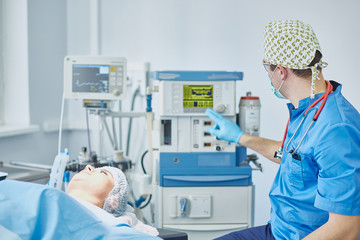 Several doctors surrounding patient on operation table during t