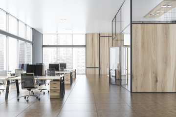 Gray and wooden open space office with hall