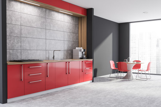 Side view of red and gray kitchen with table