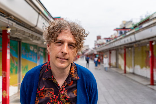 An Attractive Man Poses While Exploring Romantic Nakamise Street Market At The Historic Senso Ji Temple In Asakusa, Tokyo, Japan.