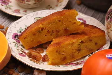 Pumpkin pie on  a plate ,pumpkin persimmon and tea.