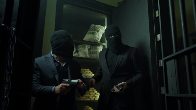 Two ardmed men robbing a bank