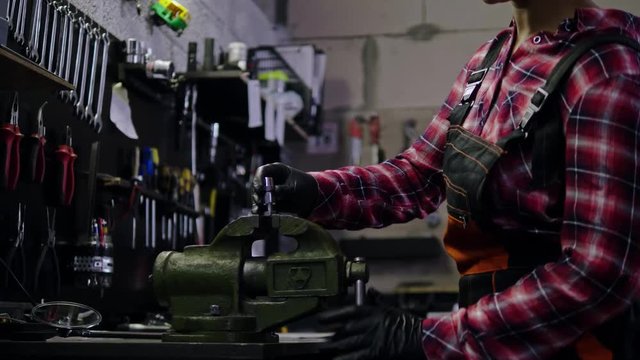 African american woman mechanic repairing a motorcycle in a workshop