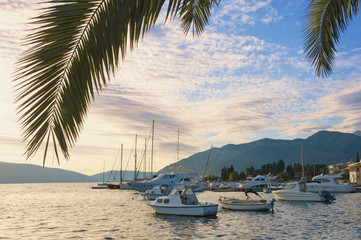 Beautiful Mediterranean landscape with fishing boats on water. Montenegro, Adriatic Sea, view of Bay of Kotor near Tivat city, autumn