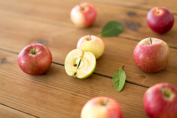 fruits, food and harvest concept - ripe red apples on wooden table