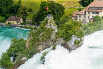 Fototapeta na wymiar A beautiful waterfall on the river Rhine in the city Neuhausen am Rheinfall in northern Switzerland.