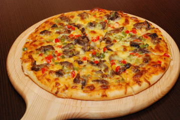 Pizza on the thin dough with cheese