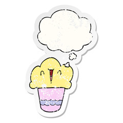 cartoon cupcake with face and thought bubble as a distressed worn sticker