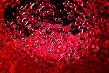 Red wine on black background, abstract splashing.