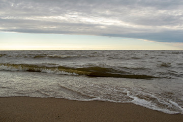 Wonderful views of the Golden sand of the beach by the sea with waves on the background of a...