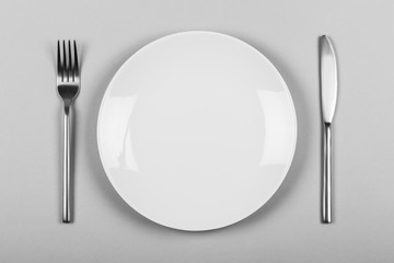 White empty plate with knife & fork