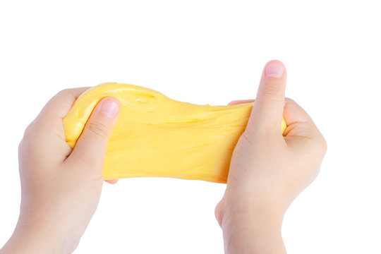 Children's hands stretch homemade goo and yellow slime.