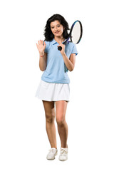 A full-length shot of a Young tennis player woman saluting with hand with happy expression over isolated white background