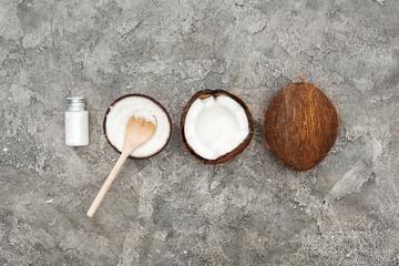 flat lay with coconuts and coconut cream on grey textured background