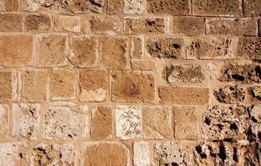 Old, brown, sandy, wall of a stone house in the open air.Close-up.
