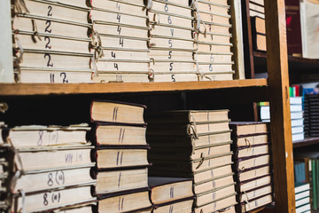 vintage and retro books on wooden shelves in library