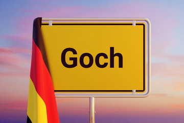 Goch. Gelbes Schild/Ortsschild. Flagge von Deutschland hÃ¤ngt darÃ¼ber. Himmel mit Sonnenuntergang oder Sonnenaufgang