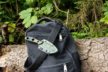 The knife in its sheath. On my belt in a holster. Backpack hike.