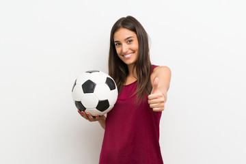 Young woman over isolated white background holding a soccer ball