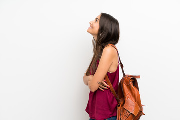 Young woman over isolated white background with backpack