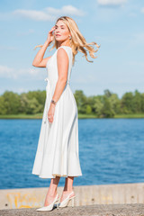 Fototapeta na wymiar Woman in silk midi vintage white dress, summer look, style for ladies 