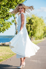 Obraz na płótnie Canvas Woman in silk midi vintage white dress, summer look, style for ladies 