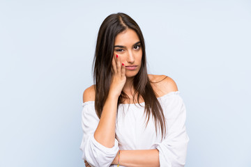 Young woman over isolated blue background unhappy and frustrated