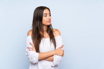 Young woman over isolated blue background thinking an idea