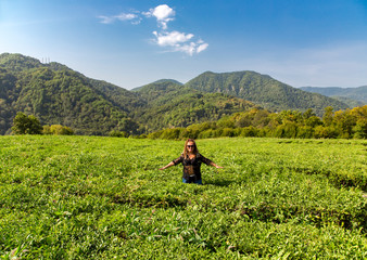 Fototapeta na wymiar Smiling woman on a mountain tea plantation in Sochi, Russia