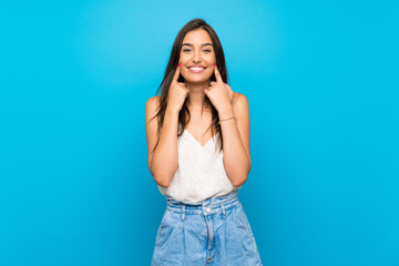 Young woman over isolated blue background with an expression of frustration and not understanding