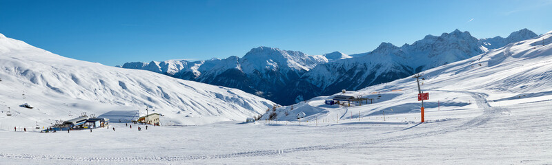Snowy mountains panoramic view from the ski piste near Scuol resort in Switzerland.