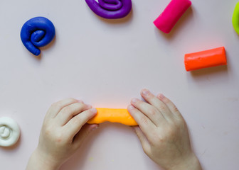 Kid play with colorful clay
