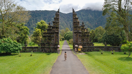 Aerial view of a lady in front of Handara gate in Bali, Indonesia.