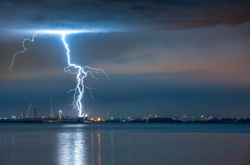 Naklejka na ściany i meble lightning strike in a storm over the city