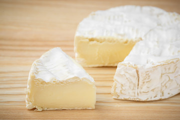 camembert soft cheese on wood background 