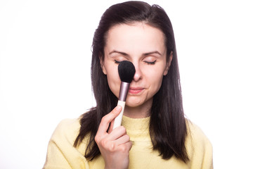 attractive girl does makeup, makeup brush