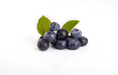Fresh blueberry with green leaves isolated on white