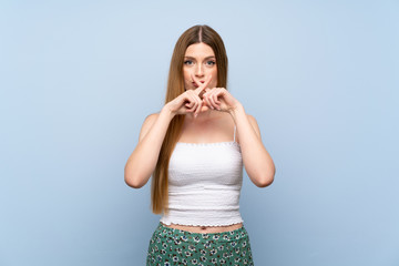 Young woman over isolated blue background showing a sign of silence gesture