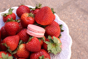 Bowl of strawberries and a strawberry macaron