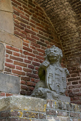 sculpture of lion against brick wall, in gate called Broerderpoort. Kampen, The Netherlands_-4