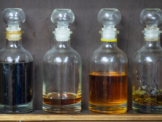 Jars with cooking oils / herbs / condiments. Different sorts of cooking oil, close-up