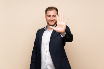 Blonde man over isolated background counting five with fingers