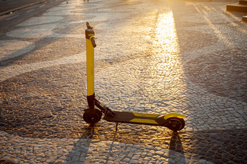 Motorised autoped left in the middle of the Copacabana boulevard at sunrise with the famous...