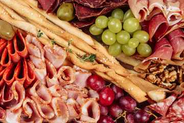 Sliced Meat Carton Box Isolated Delivery Top View. Gourmet Baked Ham, Italian Sliced Basturma and Pastrami Portion, Jamon and Walnut, Bread Stick and Grape Set in Paperboard Present Package To Go